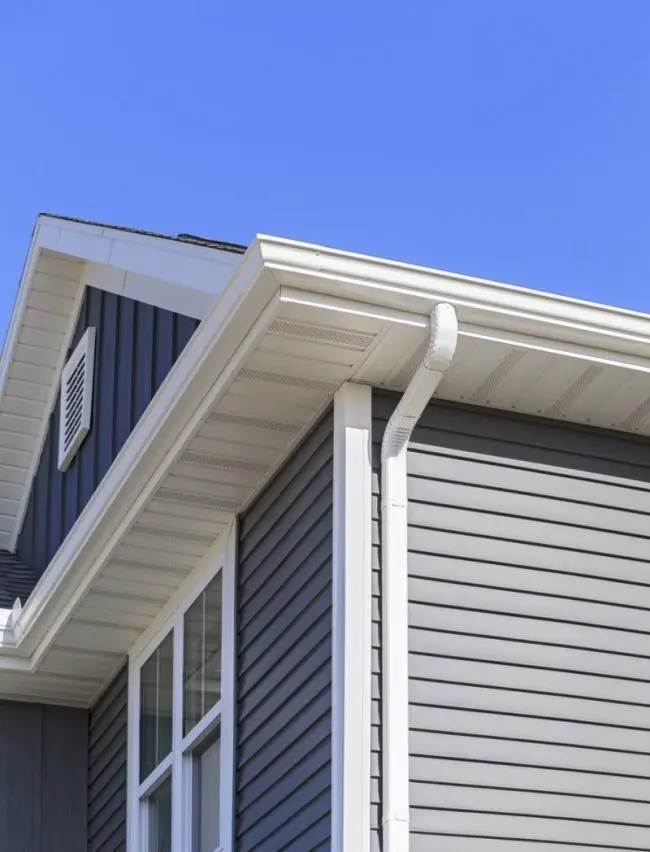 New white gutters and downspouts installed on a Jonesboro home