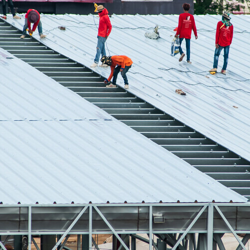 Commercial roofers working on business flat roofing